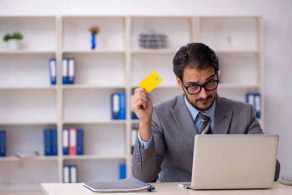 Young male employee holding credit card — Stock Photo, Image