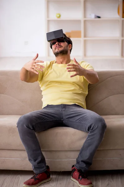 Jeune homme portant des lunettes virtuelles à la maison — Photo