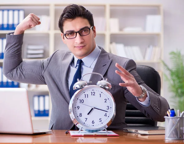Young businessman in time management concept — Stock Photo, Image
