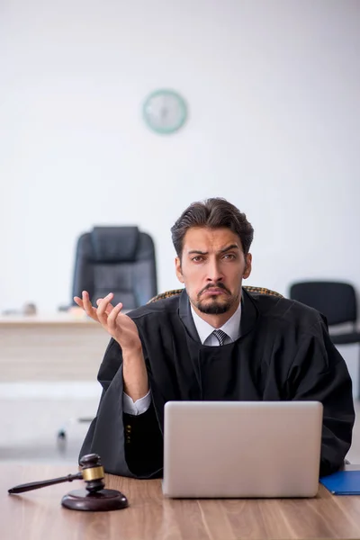 Young male judge working in the courthouse — Stock Photo, Image