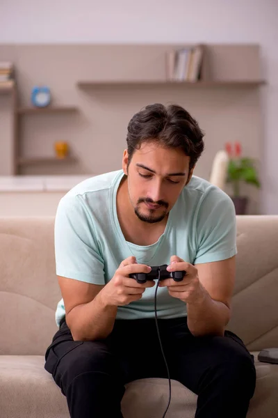 Young man playing joystick games at home — Stock Photo, Image