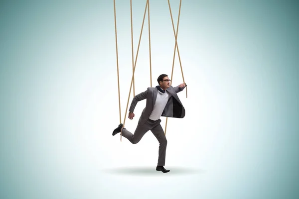 Businessman puppet being manipulated by ropes — Stock Photo, Image