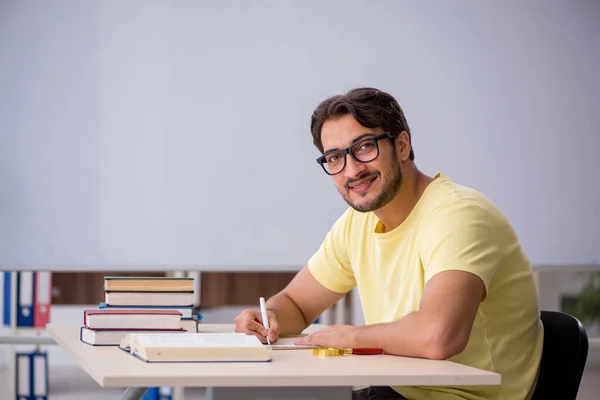 Fiatal férfi diák készül vizsgák az osztályteremben — Stock Fotó