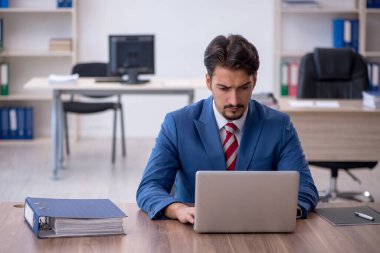 Ofiste çalışan genç bir erkek.