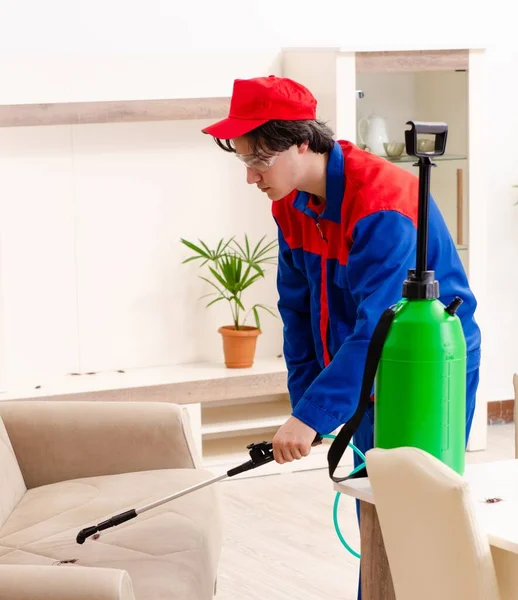 Young contractor doing pest control at home — Stock Photo, Image