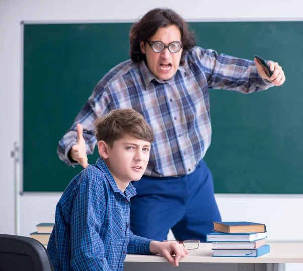 Boy using smartphone during the lesson — Stock Photo, Image