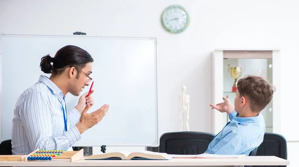 Young father helping his son to prepare for exam — Stock Photo, Image