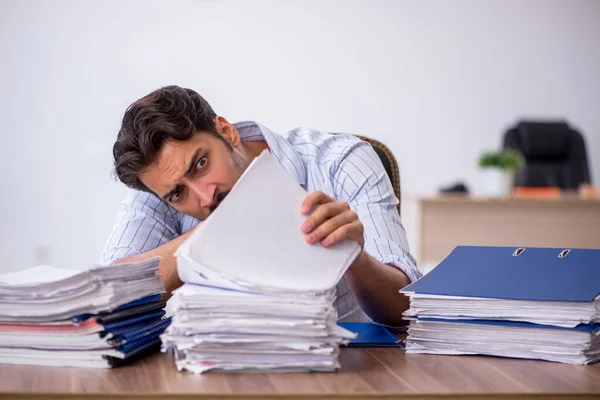 Junge männliche Mitarbeiter und zu viel Arbeit im Büro — Stockfoto