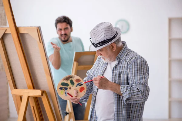 Two male painters enjoying painting at home — Stock Photo, Image