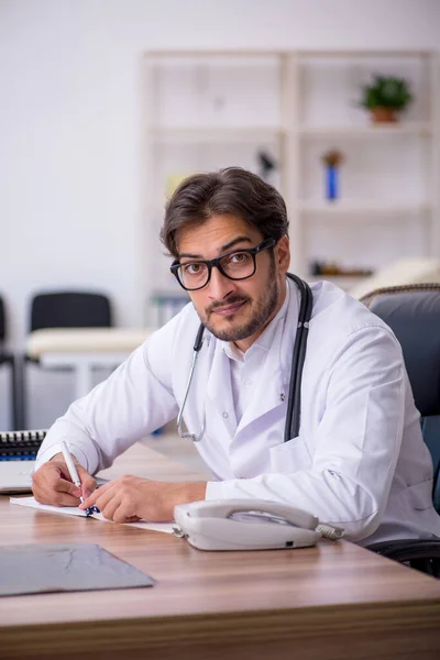 Giovane medico di sesso maschile che lavora in clinica — Foto Stock