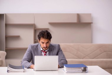 Genç erkek çalışan salgın sırasında evden çalışıyor.