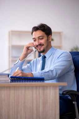 Ofiste çalışan genç bir erkek.