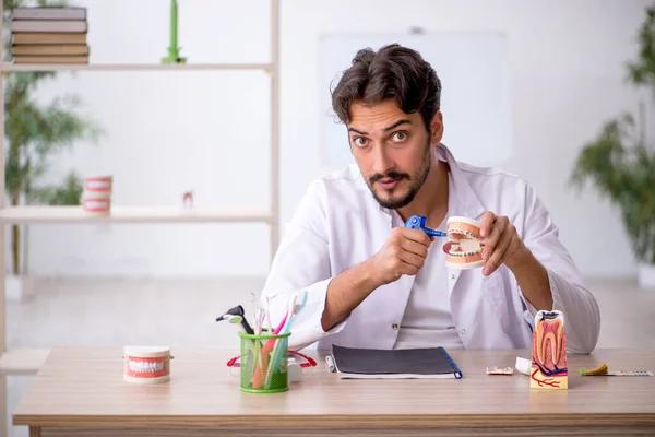 Young male dentist working in the clinic — Stock Photo, Image