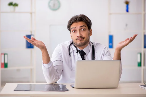 Young male doctor in telemedicine concept — Stock Photo, Image