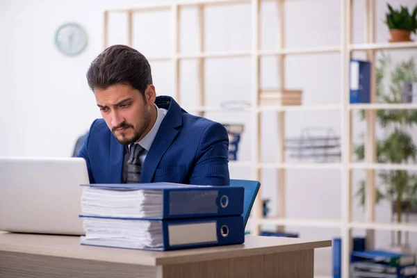 Young handsome employee working in the office — Stock Photo, Image