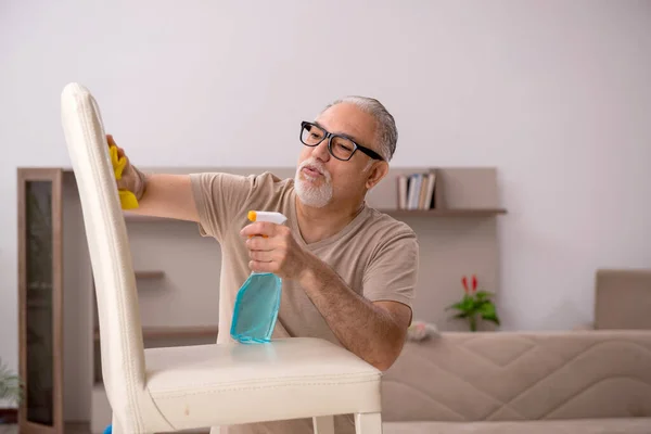 Velho fazendo tarefas domésticas em casa — Fotografia de Stock