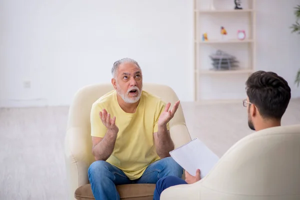 Yaşlı adam genç erkek psikoterapisti ziyaret ediyor. — Stok fotoğraf