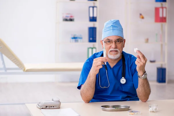 Viejo médico que trabaja en la clínica — Foto de Stock