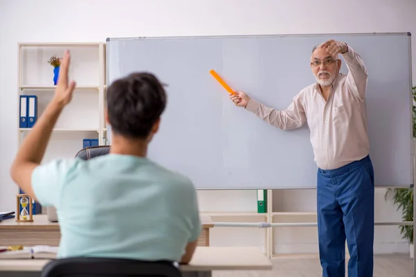 Viejo profesor y joven estudiante en el aula —  Fotos de Stock