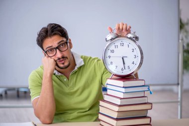 Zaman yönetimi konseptinde genç bir erkek öğrenci