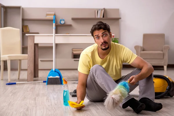 Junger Mann erledigt Hausarbeit zu Hause — Stockfoto