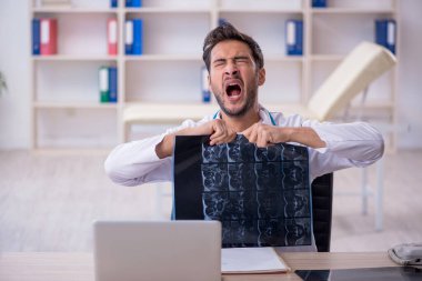 Klinikte çalışan genç bir erkek radyolog.