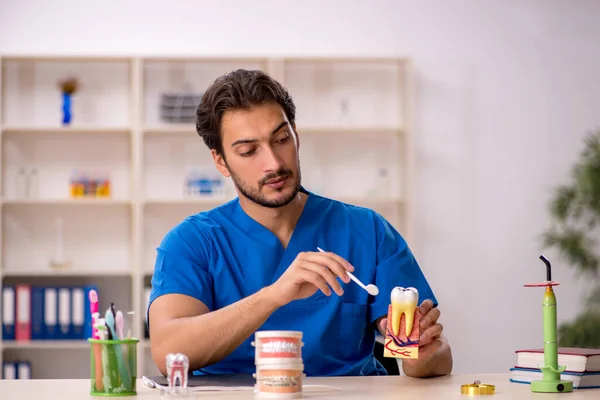 Young male dentist working in the clinic — Stock Photo, Image