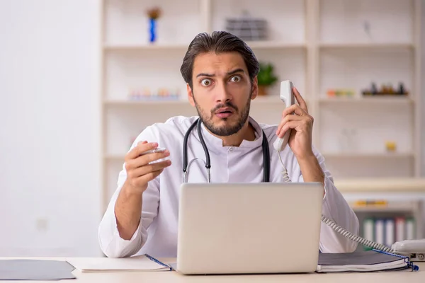 Young male doctor in telemedicine concept — Stock Photo, Image