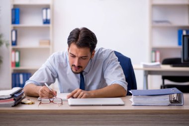 Ofiste çalışan genç bir erkek.