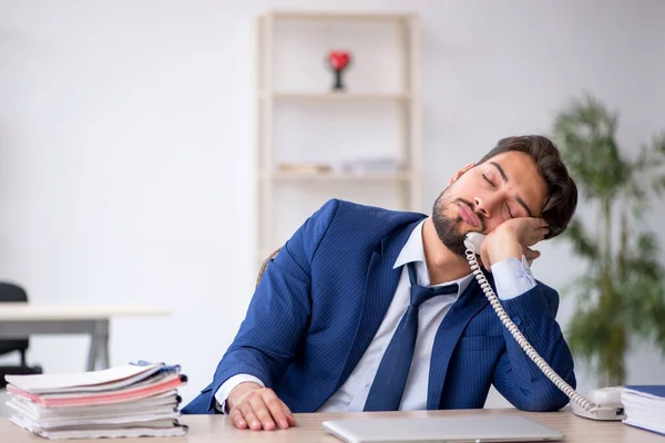 Young male employee extremely tired in the office — Stock Photo, Image