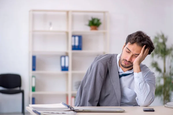 Junge männliche Angestellte in verschlafenem Konzept — Stockfoto