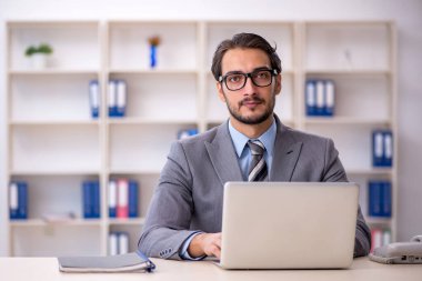 Ofiste çalışan genç bir erkek.