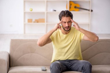 Genç adam salgın sırasında evde oturuyor.