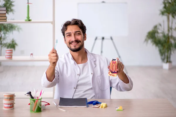 Young male dentist working in the clinic — Stock Photo, Image