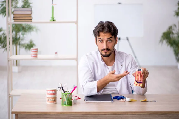 Young male dentist working in the clinic — Stock Photo, Image