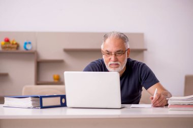 Salgın sırasında evde çalışan yaşlı bir erkek işçi.