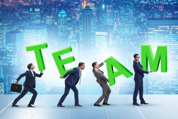 Teamwork concept with people carrying team letters — Stock Photo, Image