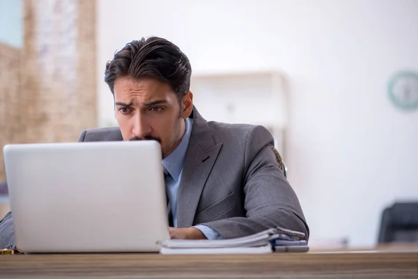 Joven empleado masculino que trabaja en la oficina — Foto de Stock