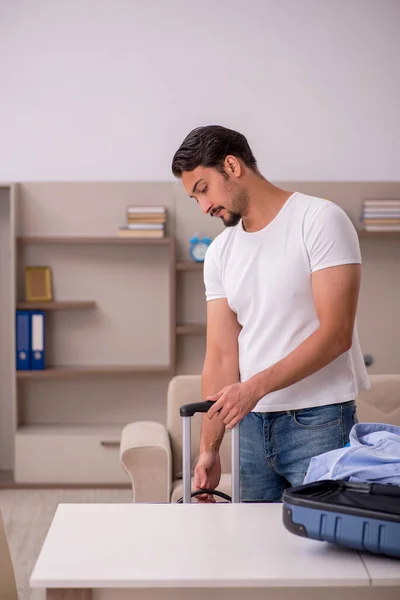 Young man preparing for trip at home — Stock Photo, Image