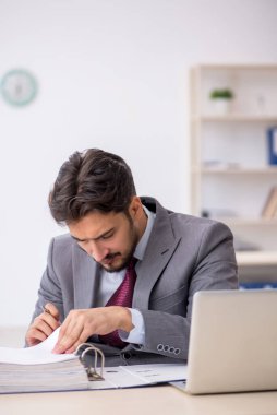 Ofiste çalışan genç bir erkek.