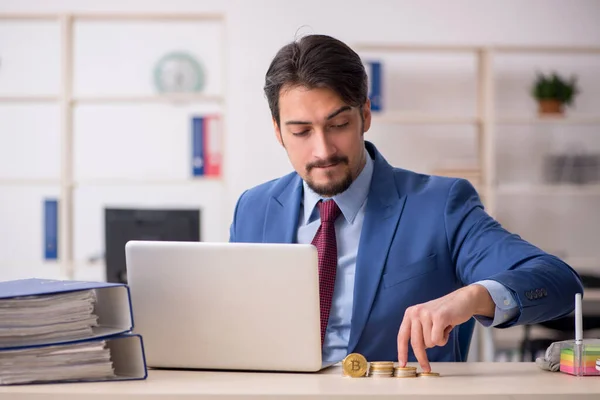 Young man earning money via Internet in cryptocurrency concept — Stock Photo, Image