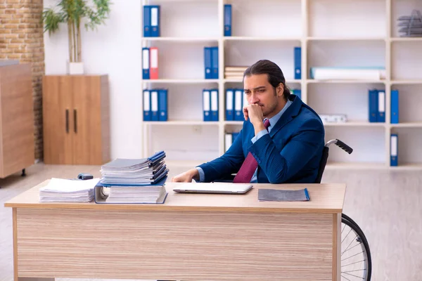 Young disabled employee working in the office