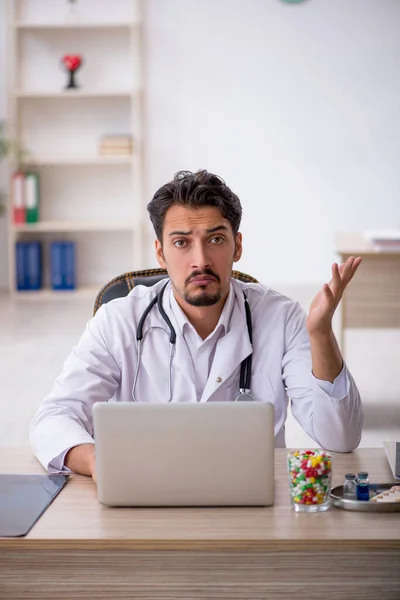 Young male doctor working in the clinic — Stock Photo, Image