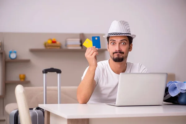 Young man preparing for trip at home — Stock Photo, Image