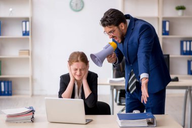 Kızgın patron ve genç bayan çalışan iş yerindeler.