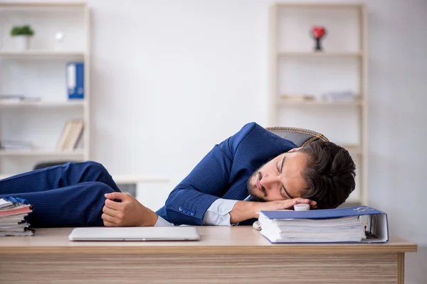 Joven empleado masculino extremadamente cansado en la oficina — Foto de Stock