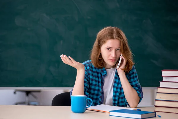 Young female student preparing for exams in the classroom — Stock Photo, Image