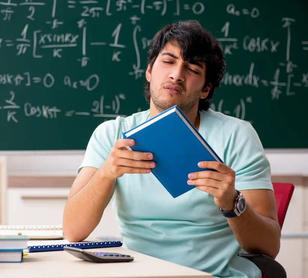 Kara tahta önünde genç erkek öğrenci matematikçi — Stok fotoğraf