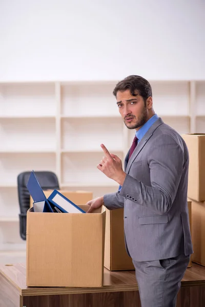 Young businessman employee in office relocation concept