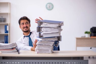 Genç işadamı işyerinde aşırı çalışmaktan memnun değil.